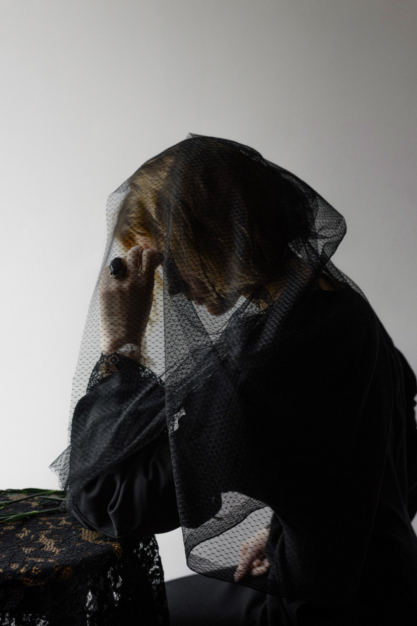 A lady crying in her room.