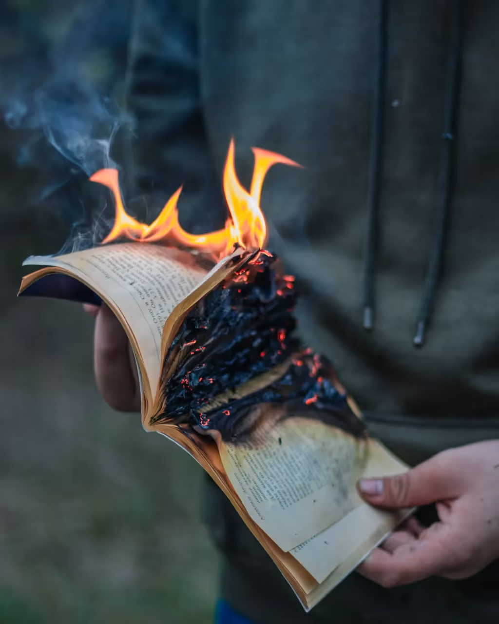 A person burning a book.