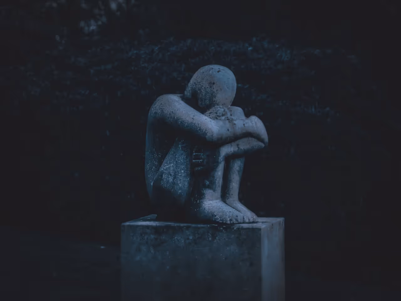 A statue in a grieving pose.
