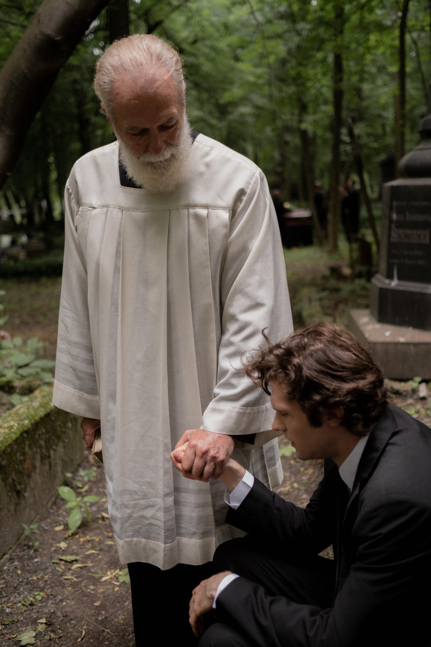 A priest holding a man