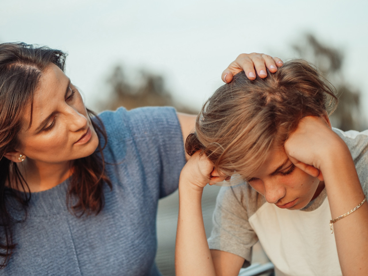A mother consoling her child.