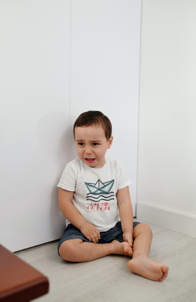 A boy sitting and crying.