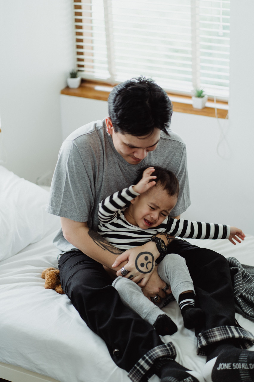 A father consoling his child.