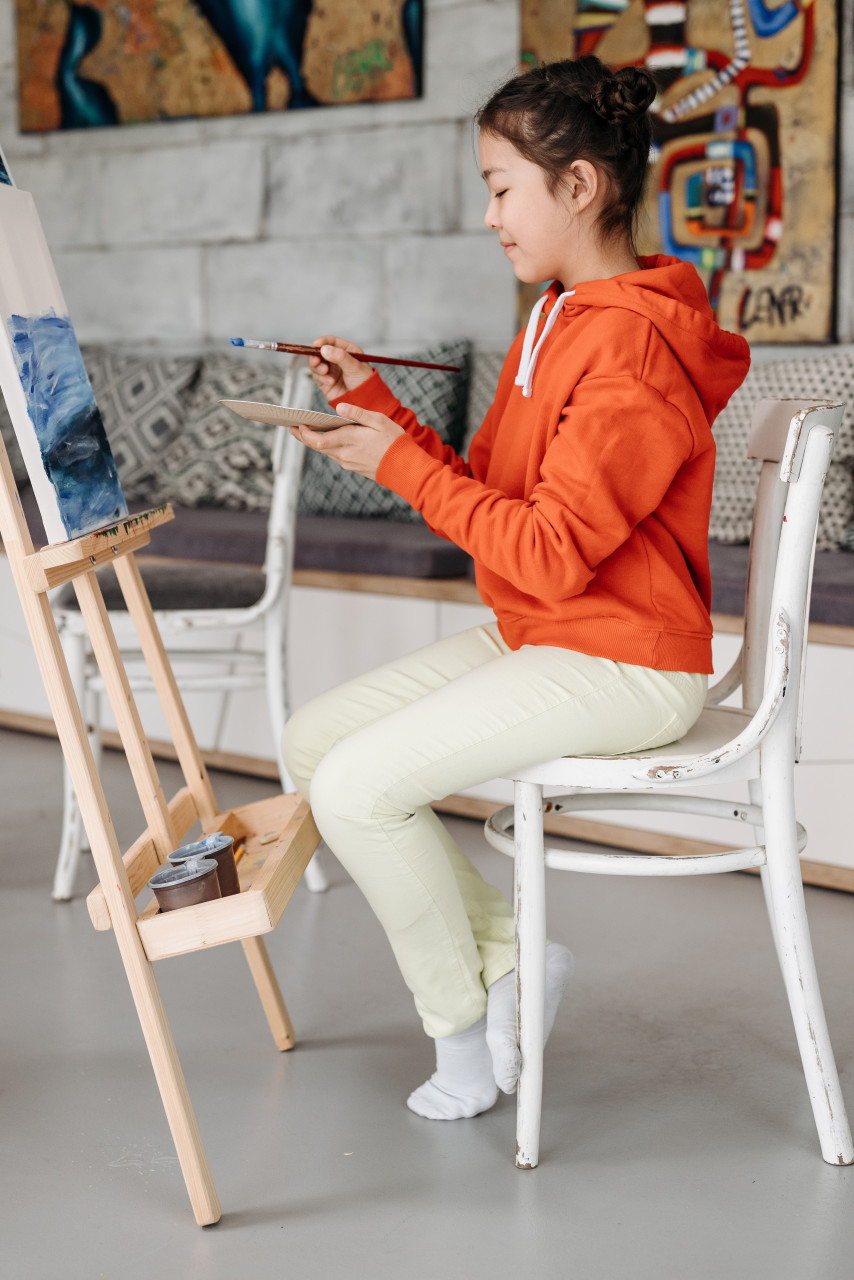 A student painting in school.