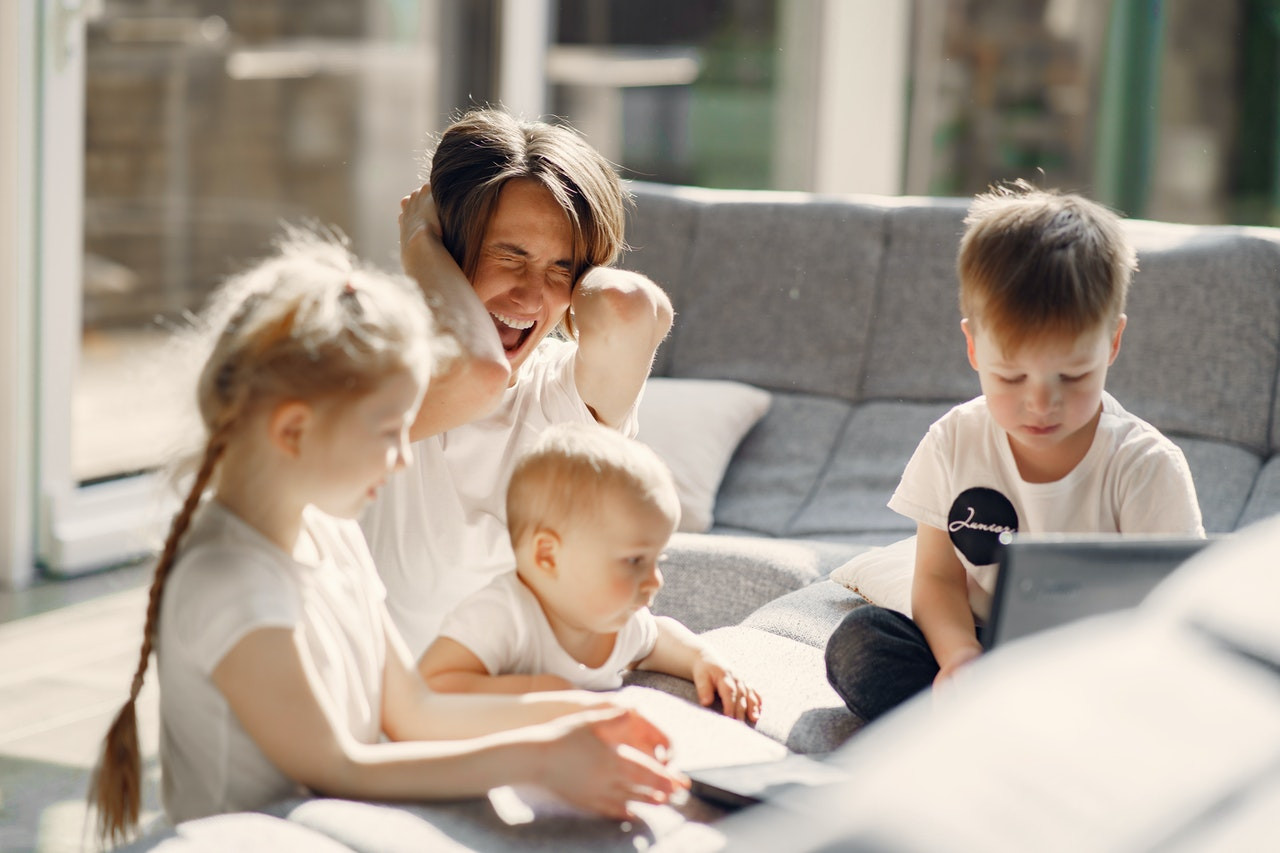 mom screaming with kids sitting on the couch