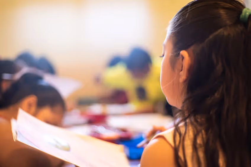 a child holding paper in class