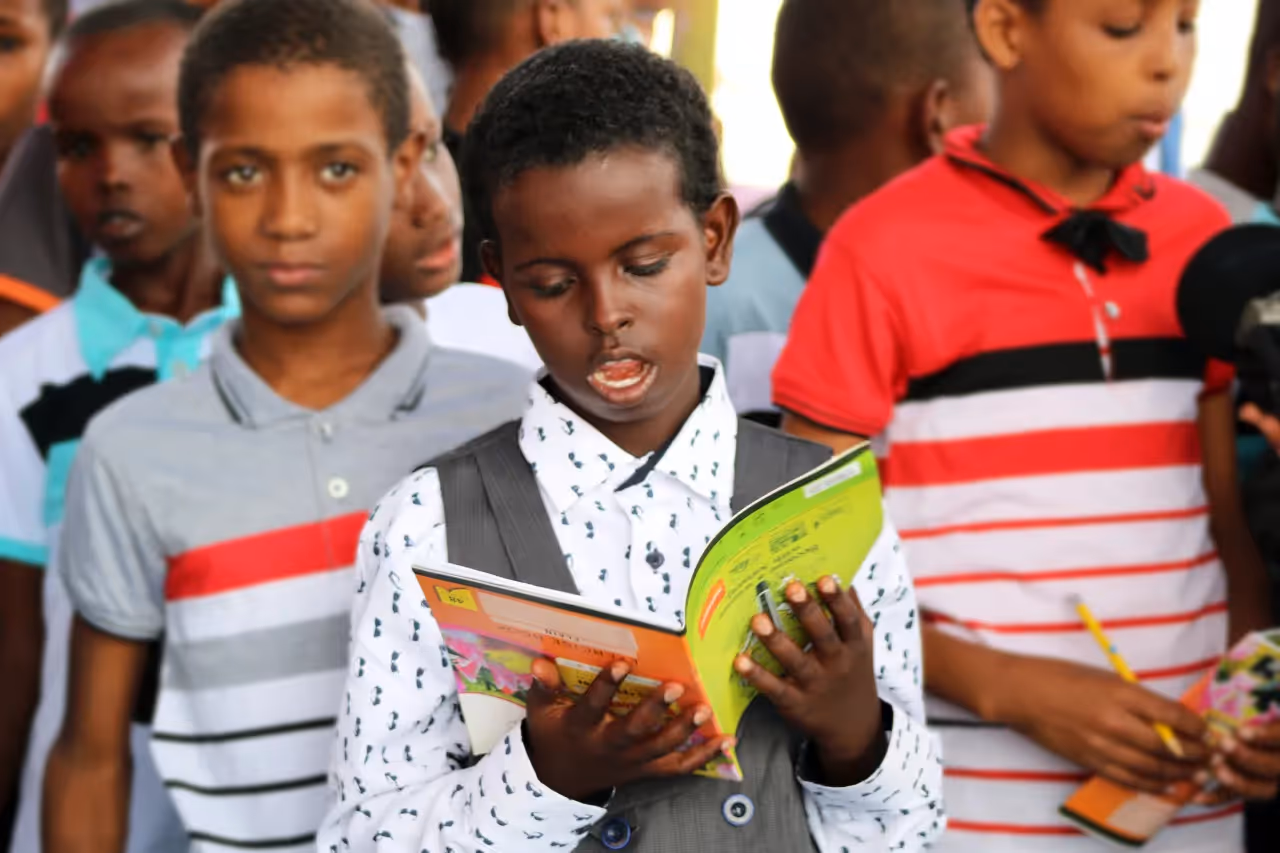 A child reading out from a book.