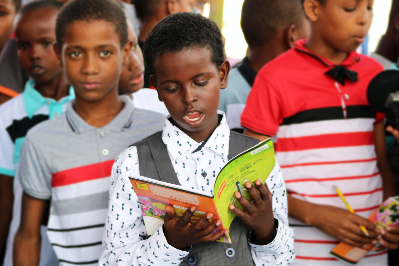 A child reading out from a book.
