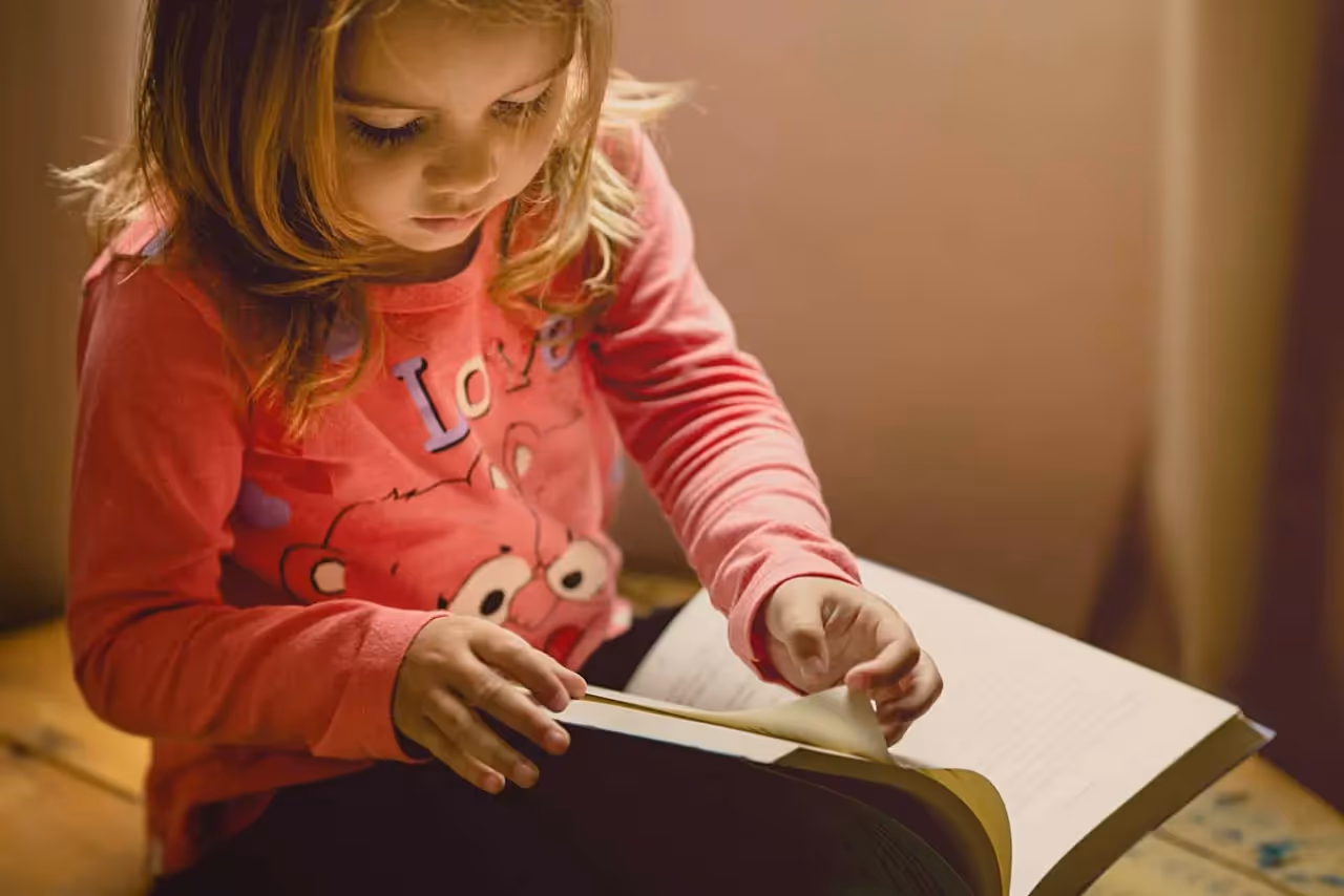 young child reading a book