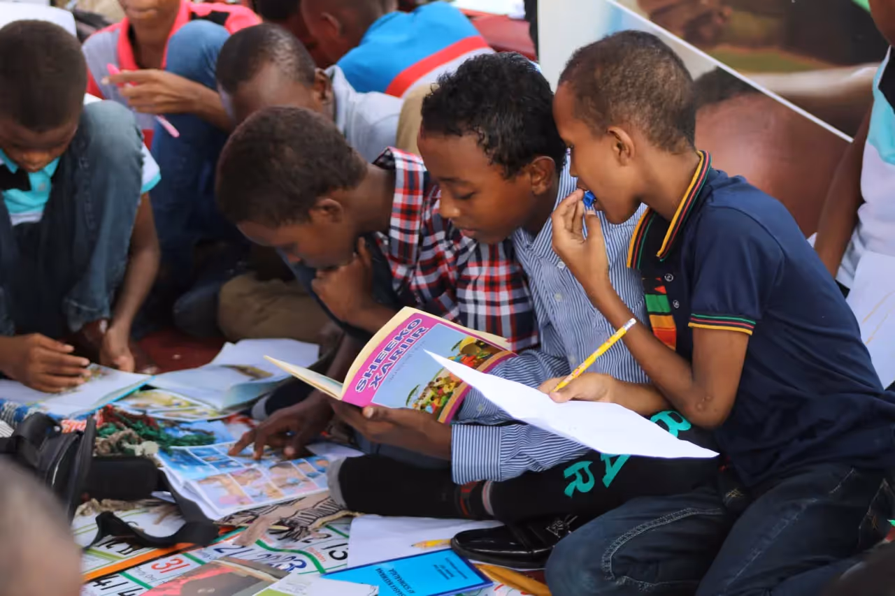 young children being friends and reading
