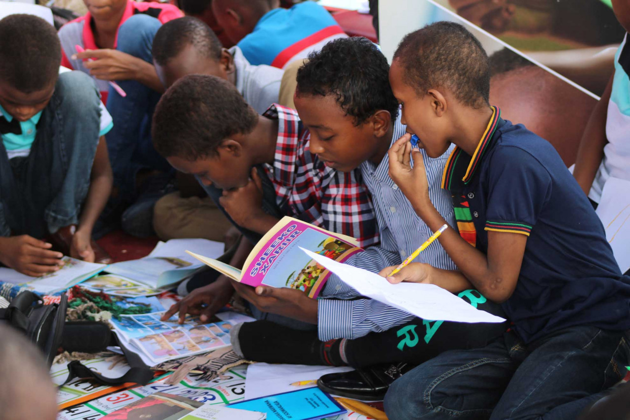 young children being friends and reading
