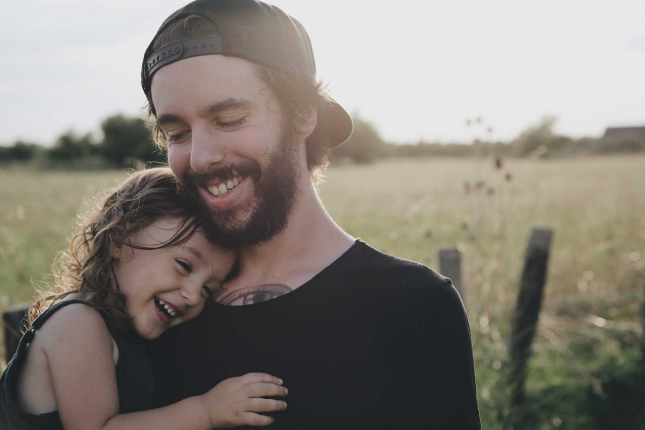 a father holding his daughter