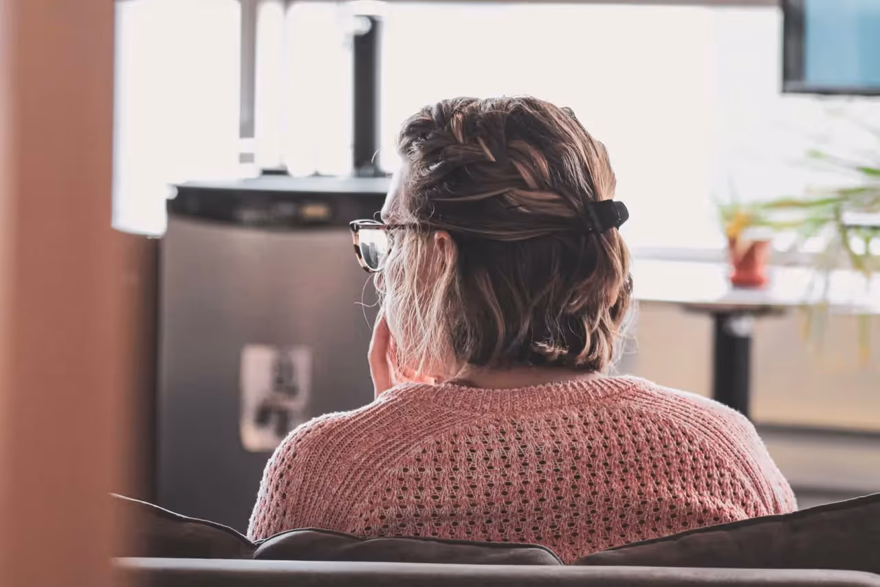 a woman sitting in a chair in an office