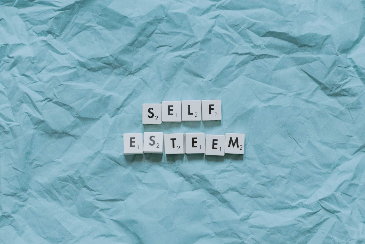 the word self esteem is spelled out on scrabble tiles