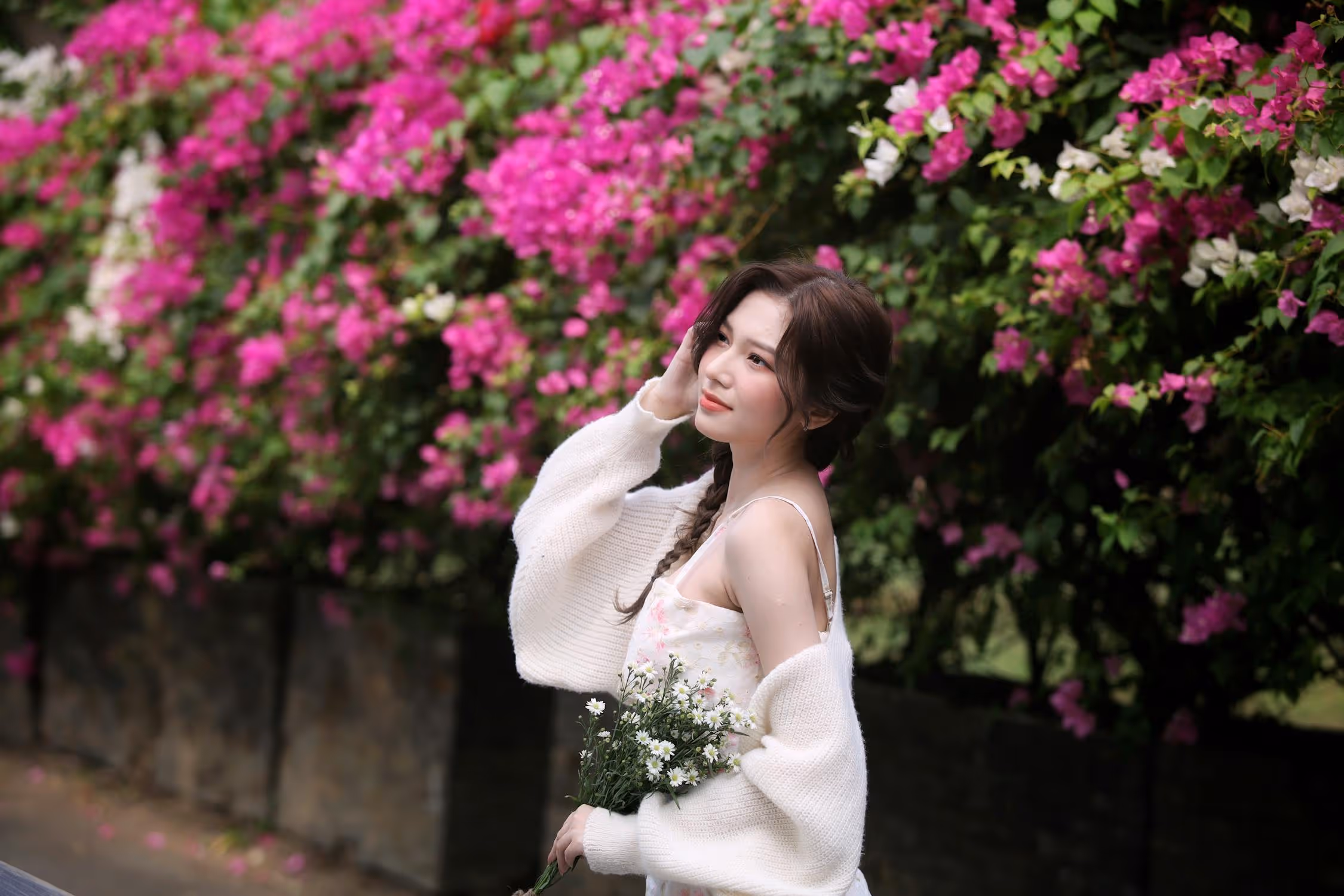 Woman Wearing White Holding Flowers