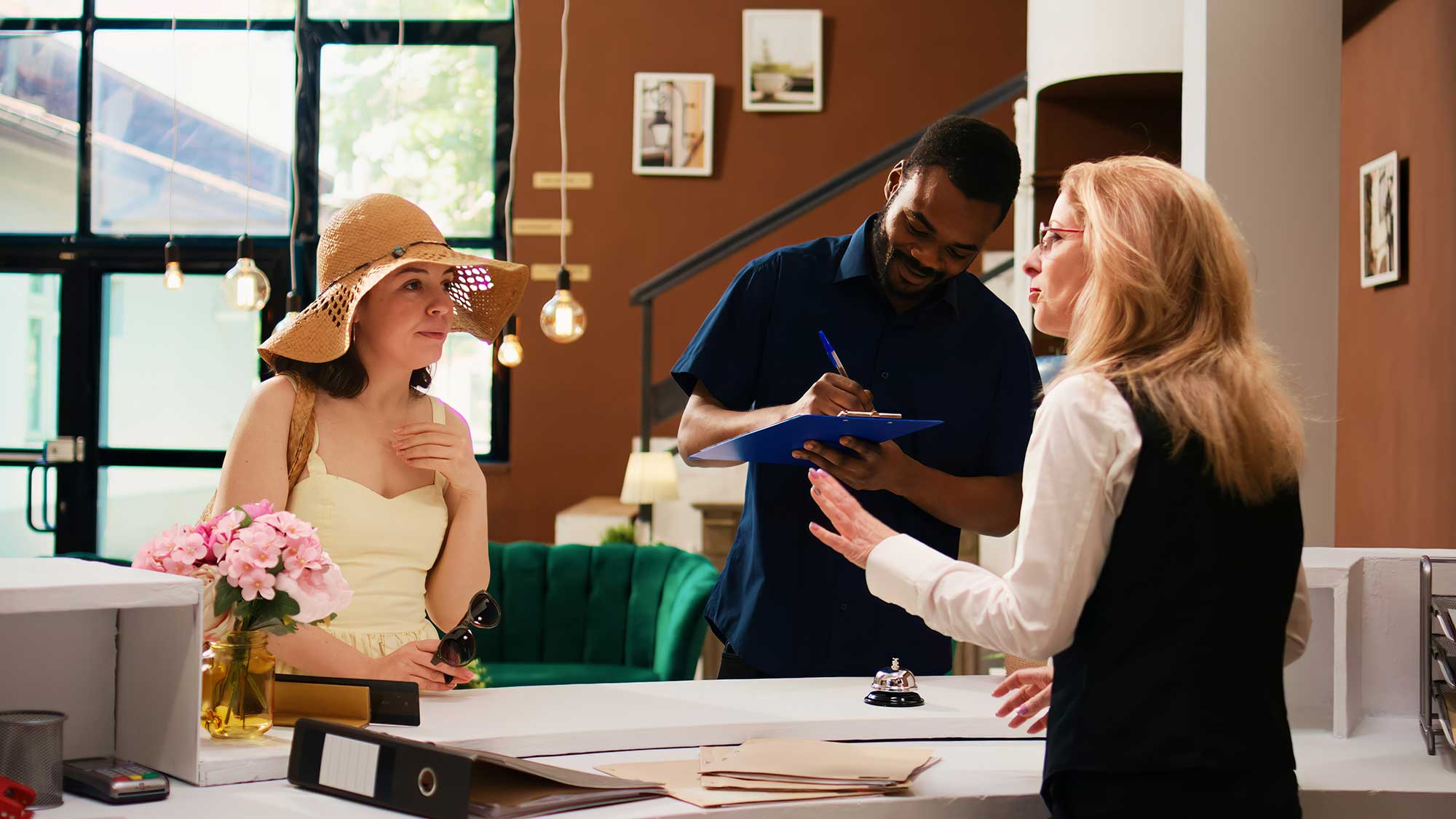 hotel guest being checked in at front desk