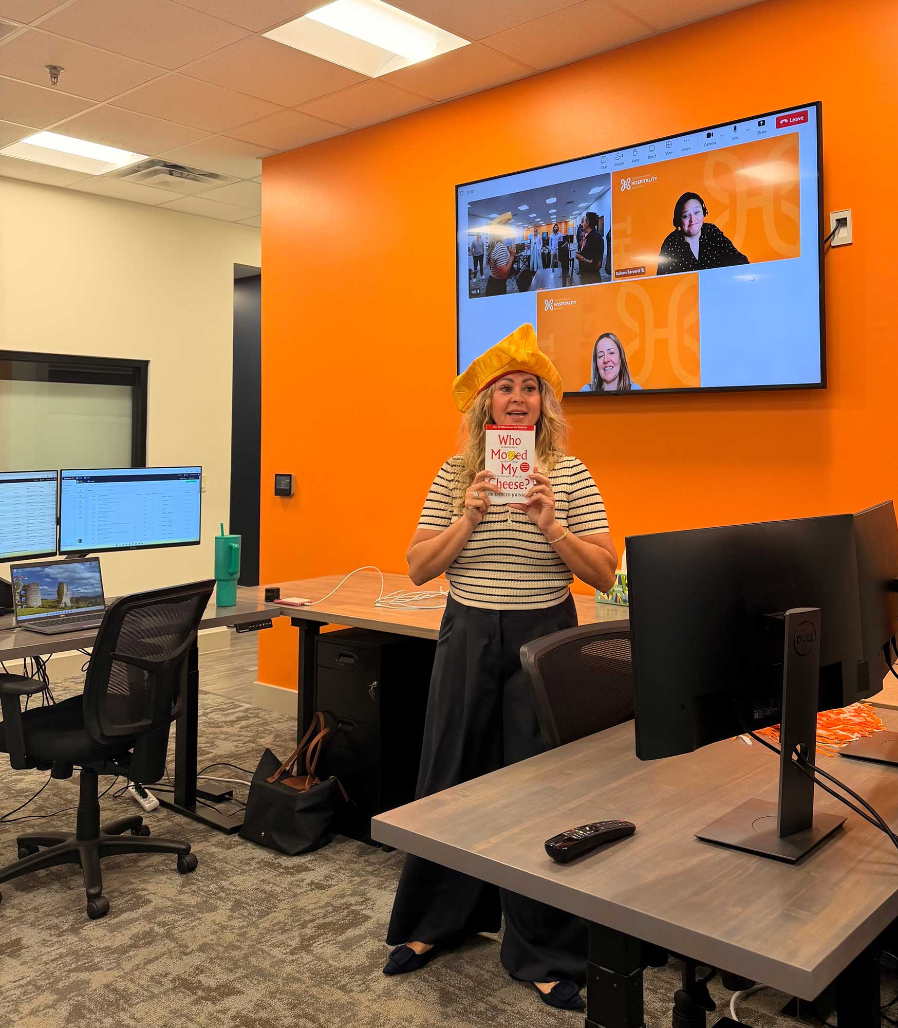 During a Monday morning staff meeting, Founder and CEO Katie Schorn discusses Who Moved My Cheese, an international business bestseller, as the team delves into a discussion around how AI is changing the industry.