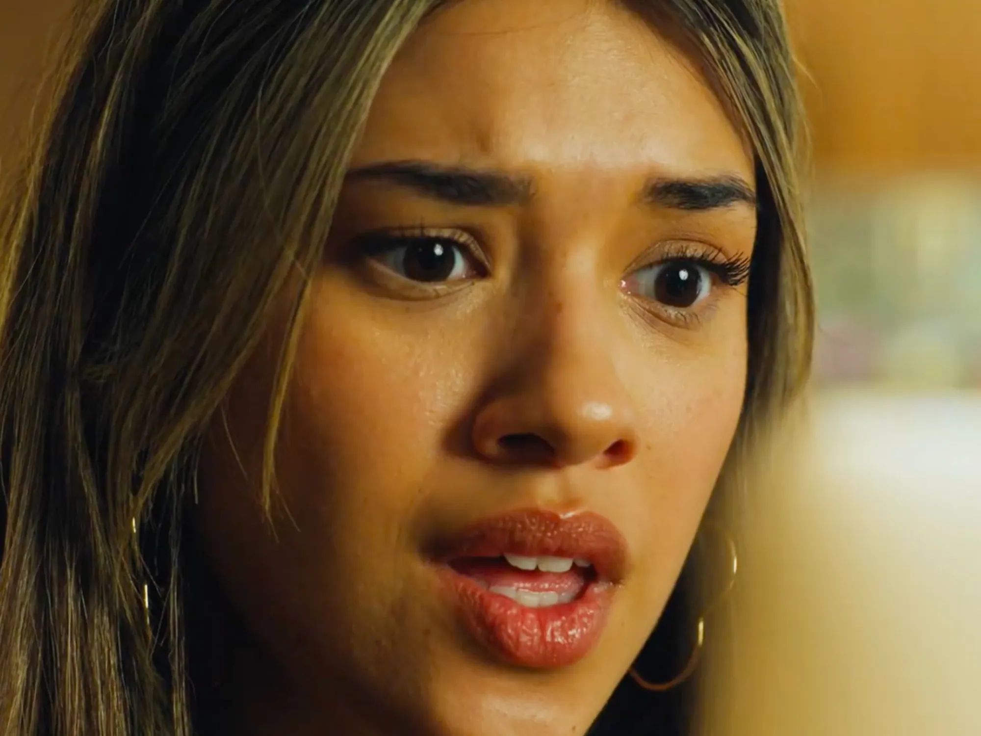 Video still of a young woman with a worried expression