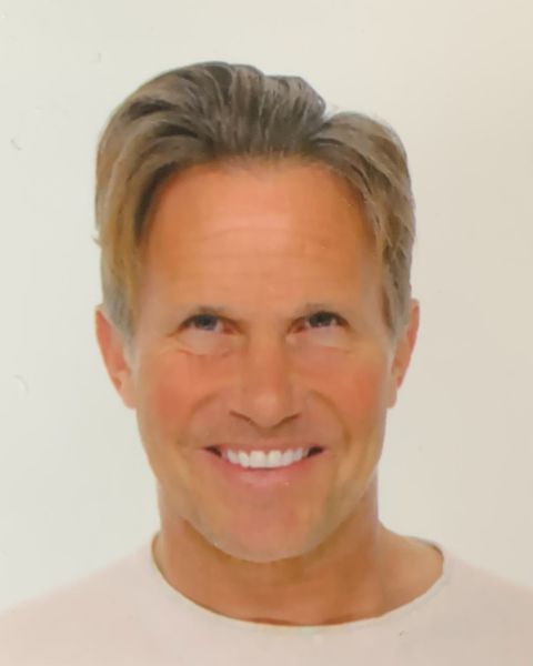 Stephen Conley, Gisteo, specializing in Video Production & Editing, from Miami, Florida, head-and-shoulders portrait of a middle-aged man with light brown hair swept back, wearing a light-colored crew-neck shirt and smiling against a plain white background.
