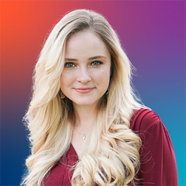 Versaviya Despars, Pivot Branding, specializing in Pitch Deck Narrative Designer, from Clayton, North Carolina, is shown in a head-and-shoulders portrait as a fair-skinned woman with long wavy blonde hair and blue-green eyes, wearing a maroon blouse, a small pendant necklace and drop earrings, smiling gently against a multicolored gradient background.