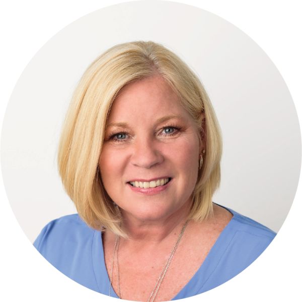 Darla Kirchner, Kirchner Markeitng, LLC, specializing in Marketing/Branding Strategist, Fractional CMO, from Hilton Head Island, South Carolina, head-and-shoulders portrait of a smiling woman with shoulder-length blonde hair styled in a straight bob, blue eyes, wearing a light blue blouse and a silver necklace, posed against a plain white circular background.