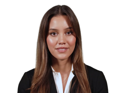 Smiling woman with long brown hair wearing a black blazer and white shirt, facing forward.