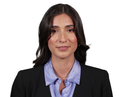 Portrait of a woman with long dark hair wearing a black blazer and a light blue collared shirt, smiling slightly.