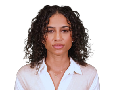Portrait of a woman with curly dark hair wearing a white shirt and a light-colored vest.