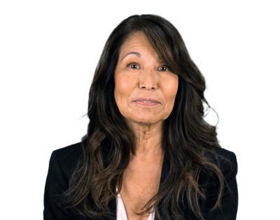 Woman with long dark hair wearing a black blazer and white top, smiling slightly against a white background.