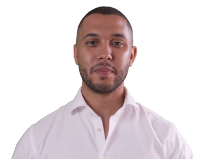 Man with short hair and beard wearing a white shirt looking directly at the camera.