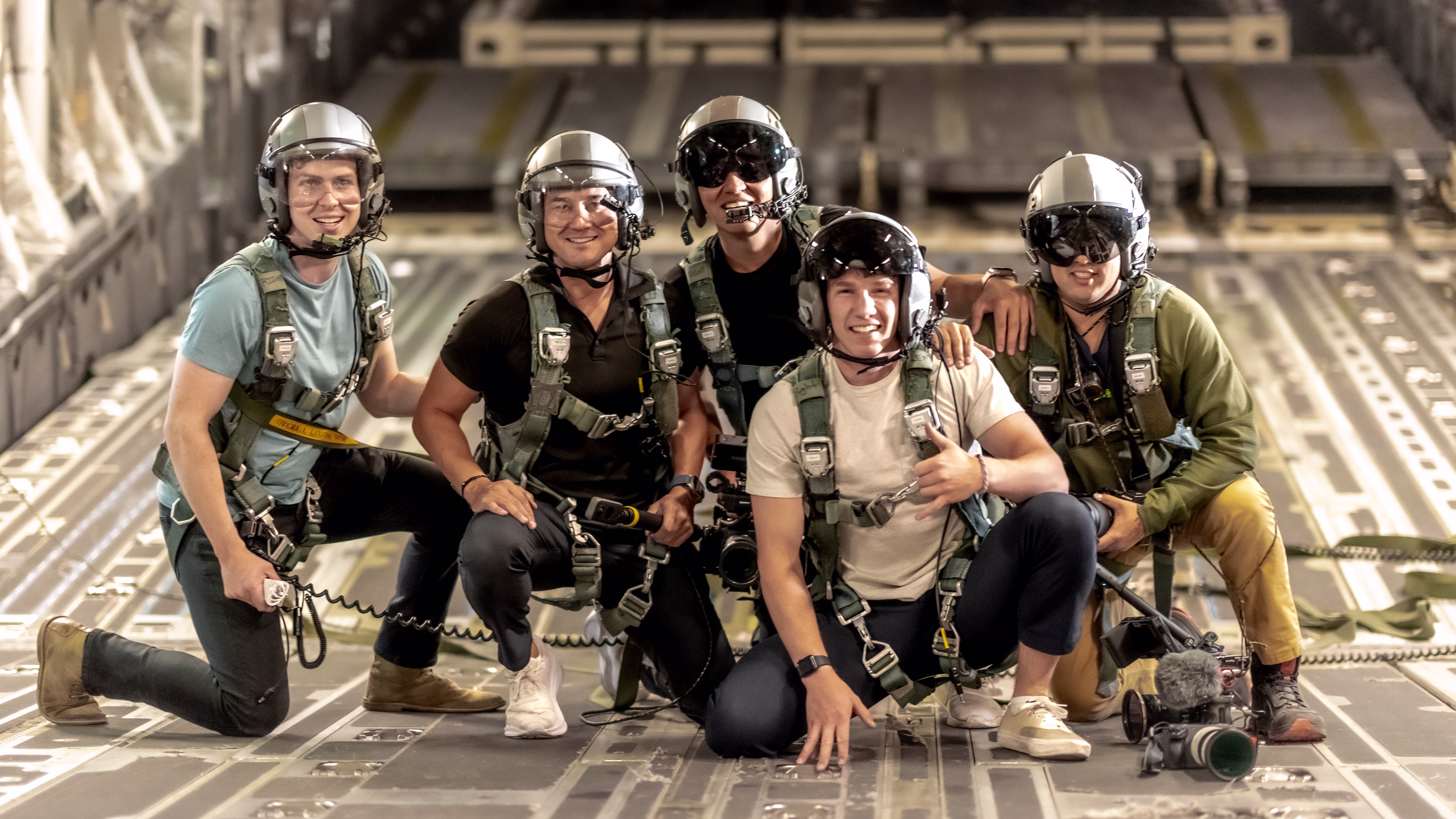 A picture of Sam Eckholm with a group of people in helmet on the back of a plane