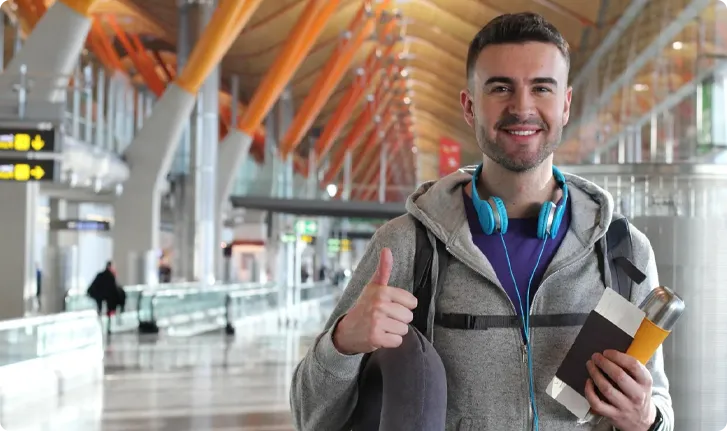 Black private jet aircraft on a flat surface with a cloudy sky background.