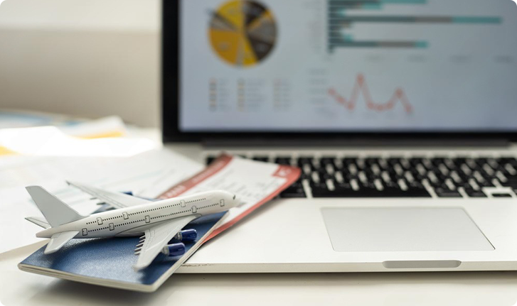 Black private jet aircraft on a flat surface with a cloudy sky background.