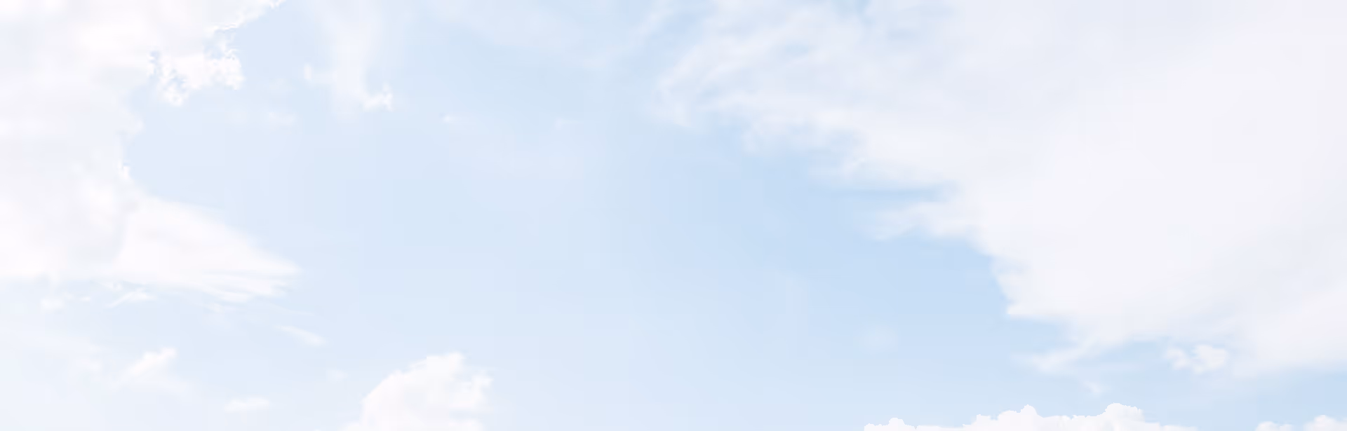 Blue sky with scattered white clouds.