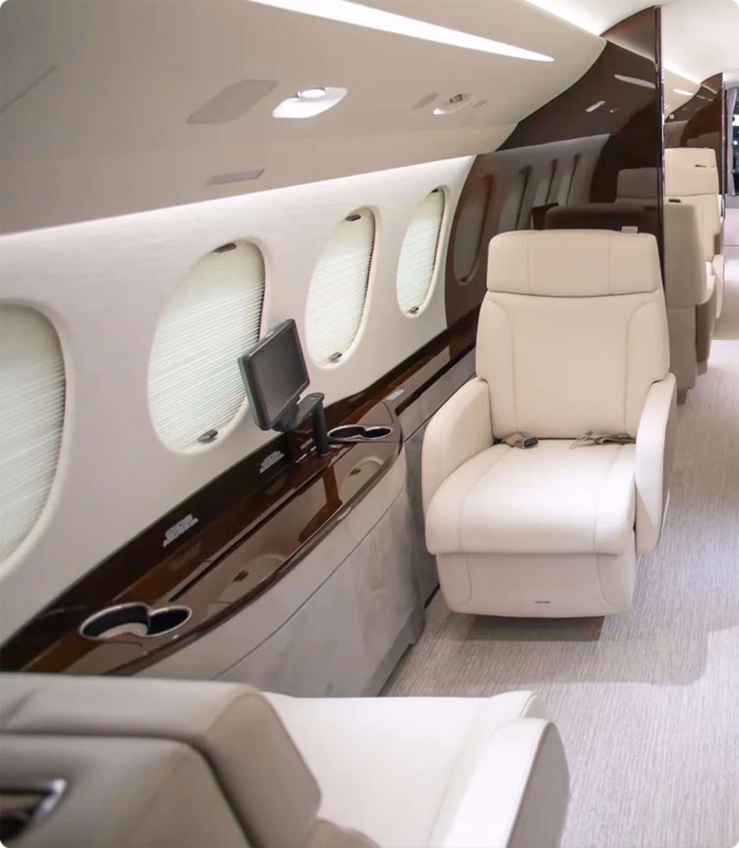 The inside of a private jet with a television.
