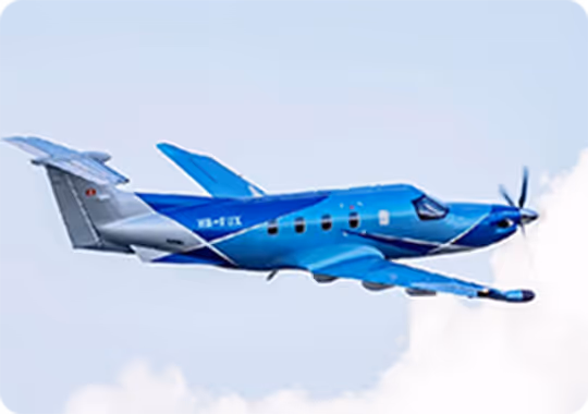 A blue and white plane flying in the sky.