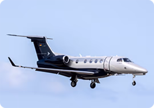 A small jet flying through a blue sky.