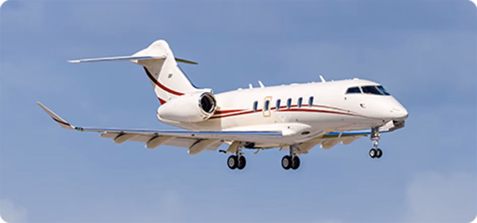 White private jet with red stripe flying against clear blue sky with landing gear down.