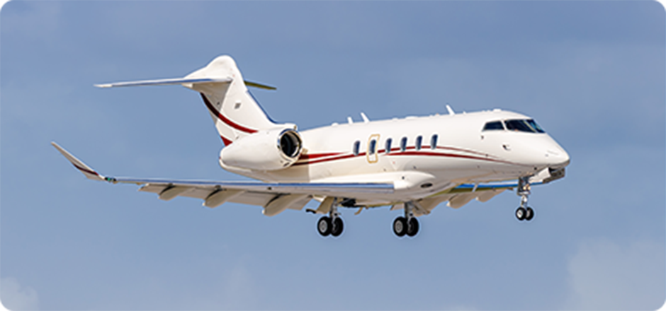 White private jet with red stripe flying against clear blue sky with landing gear down.