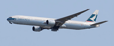 Cathay Pacific airplane flying in clear blue sky.