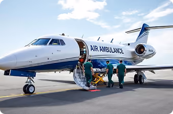Medical team loading a patient on a stretcher into an Air Ambulance jet at an airport.