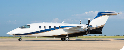 White and blue private jet on runway with clear sky background.