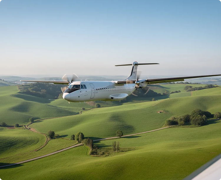 White twin-propeller airplane flying over green rolling hills under clear sky.