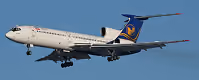 Passenger airplane with landing gear extended flying against clear blue sky.
