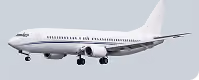 White commercial jet airplane with landing gear extended flying against a gray sky.