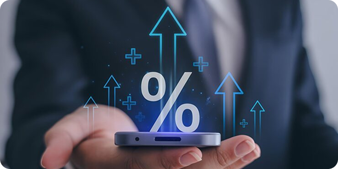 A person holding a smartphone with glowing percentage and upward arrows symbols emerging from the device, representing growth or increasing rates.