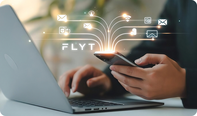 Person holding a smartphone over a laptop keyboard with digital icons of email, Wi-Fi, cloud, and notifications emitting upward from the phone, with the word 'FLYT' displayed.