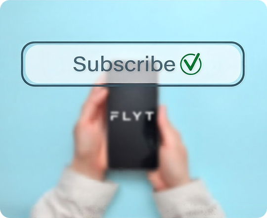 Blurred image of hands holding a smartphone with the word 'FLYT' on the screen and a clear overlay button above displaying the word 'Subscribe' with a green checkmark.