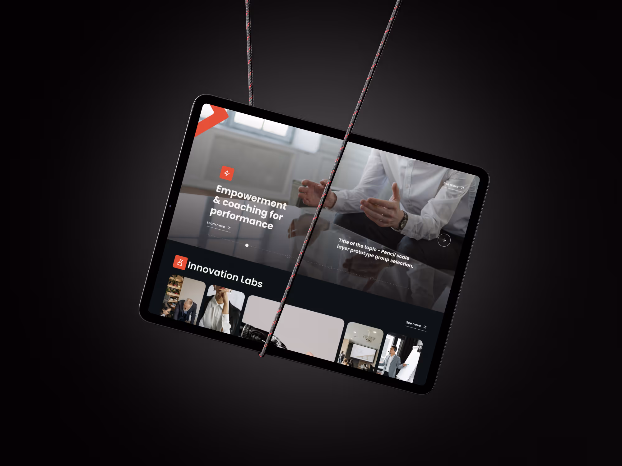 Tablet hanging by two ropes displaying a Aspelian webpage about empowerment, coaching for performance, and innovation labs.