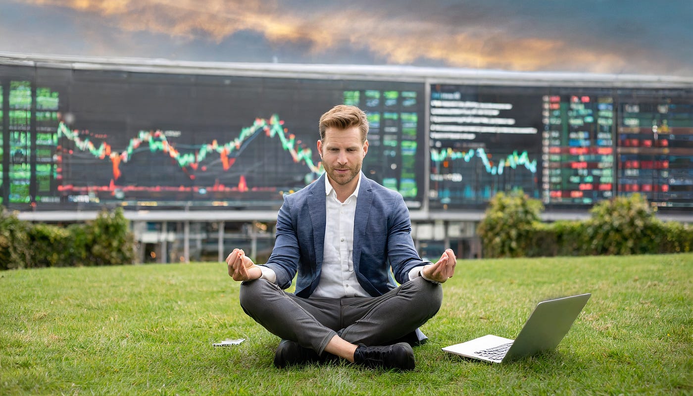 man sitting on grass with a laptop - Practice Futures Trading
